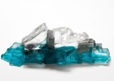 Another view of a glass sculpture in aquamarine, grey and clear