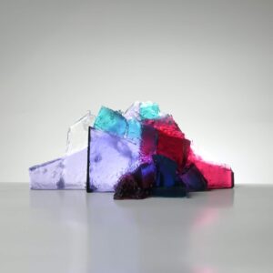 Handmade glass sculpture in the form of a fallen wall in clear, aqua, red and lilac