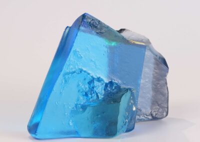 Handmade glass sculpture in the form of a fallen wall in light and dark blue with gold leaf