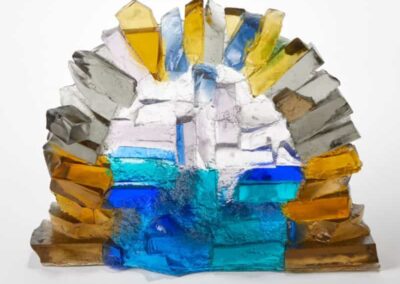 Colourful glass art sculpture with abstract design and textured surface.