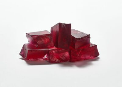 A different view of a glass sculpture suggesting rocks surrounded by pink heathers