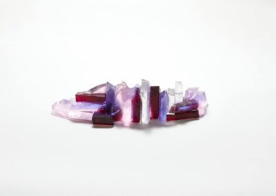 The reverse of a glass rocky outcrop in pinks and lilacs