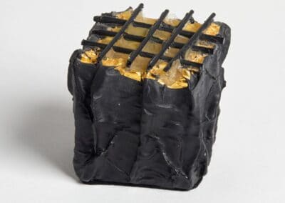 Elegant black and gold glass csulpture with geometric pattern, perfect for contemporary interior decor.