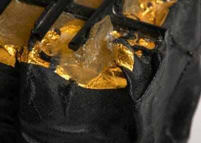 Gold leaf application on a glass sculpture project, highlighting luxury and artistic detail.