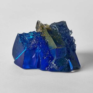 A rocky outcrop under blue sky and sun, sculpture by Deborah Timperley