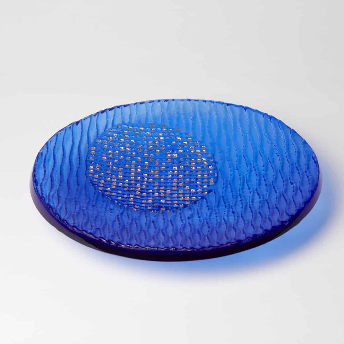 Blue glass decorative plate with textured surface and gold accents.