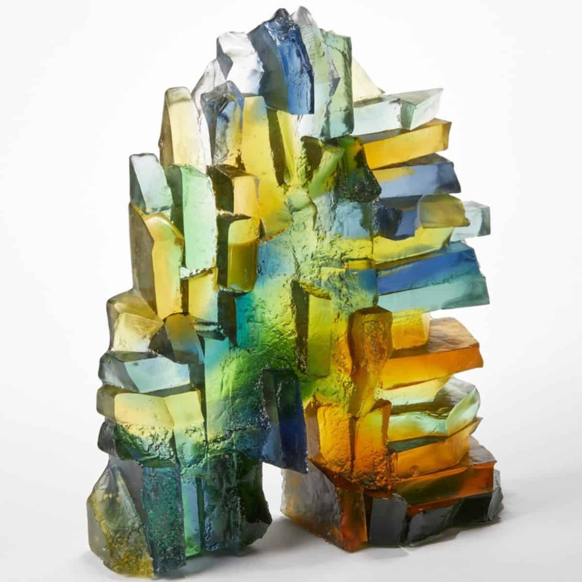 Rainbow coloured glass sculpture with geometric shapes and vibrant hues.