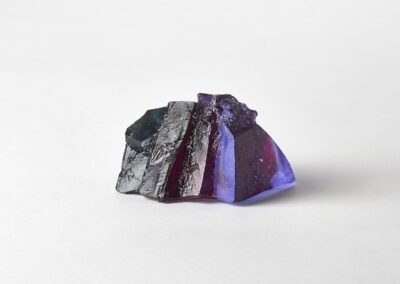 Rocky outcrop surrounded by purple heathers. Landscape glass sculpture by Deborah Timperley.